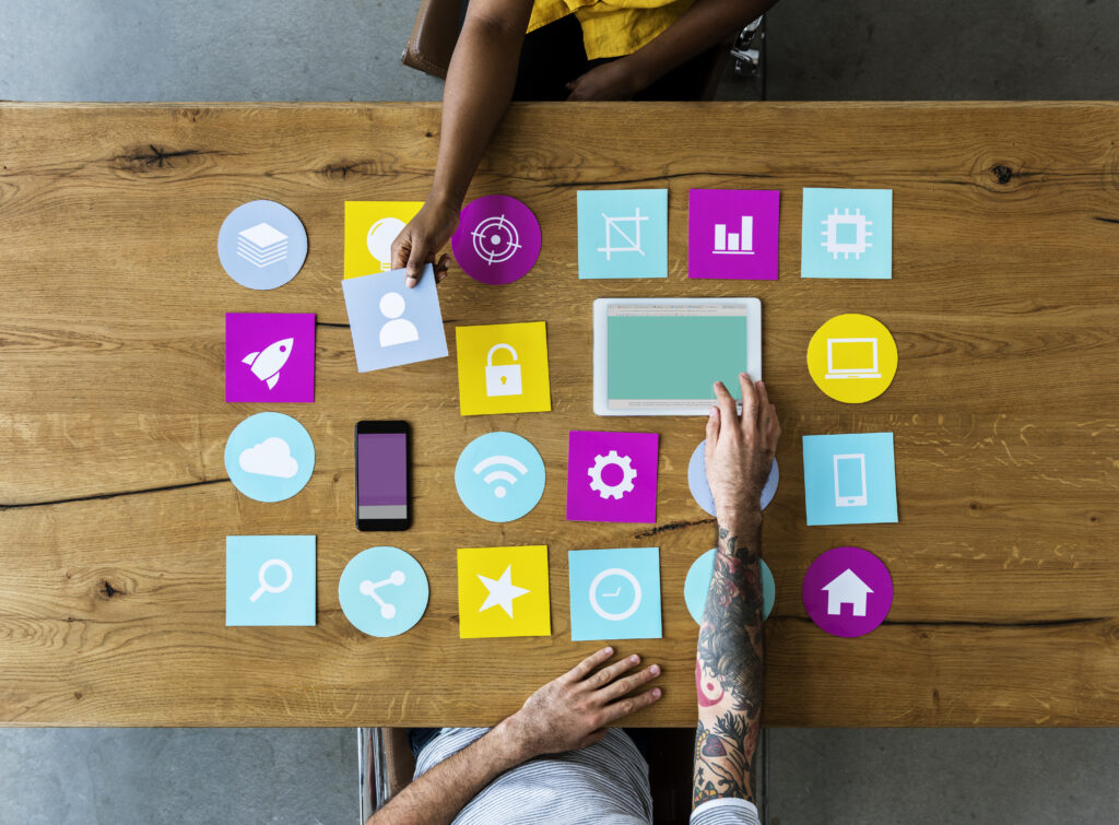 Group of computer icon on the wooden table | Marketing Materials